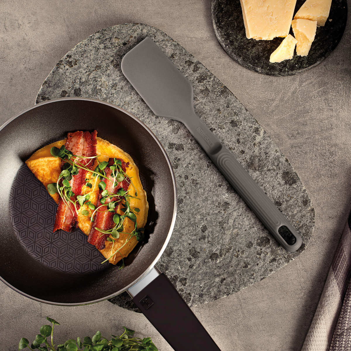 Grey silicone spatula with wide head and textured grip handle