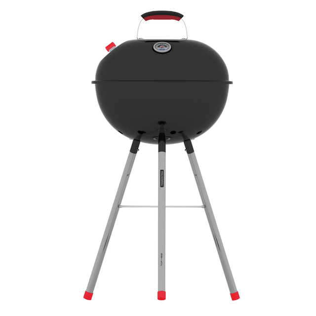 Charcoal barbecue grill with round lid and red handles on three metal legs
