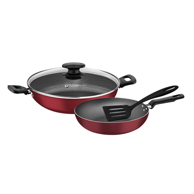 Red non-stick cookware set: two skillets with glass lid and black handles.