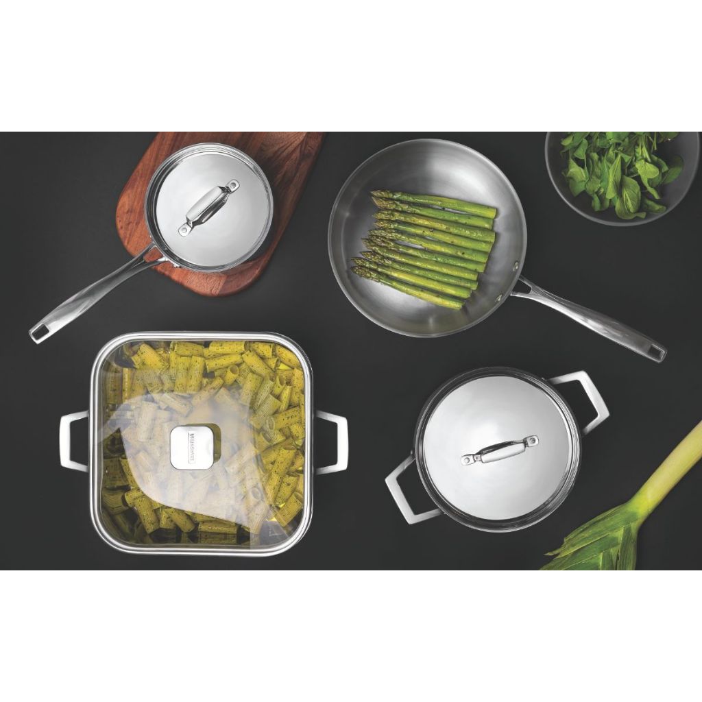 Stainless steel cookware set with multiple pans and lids arranged